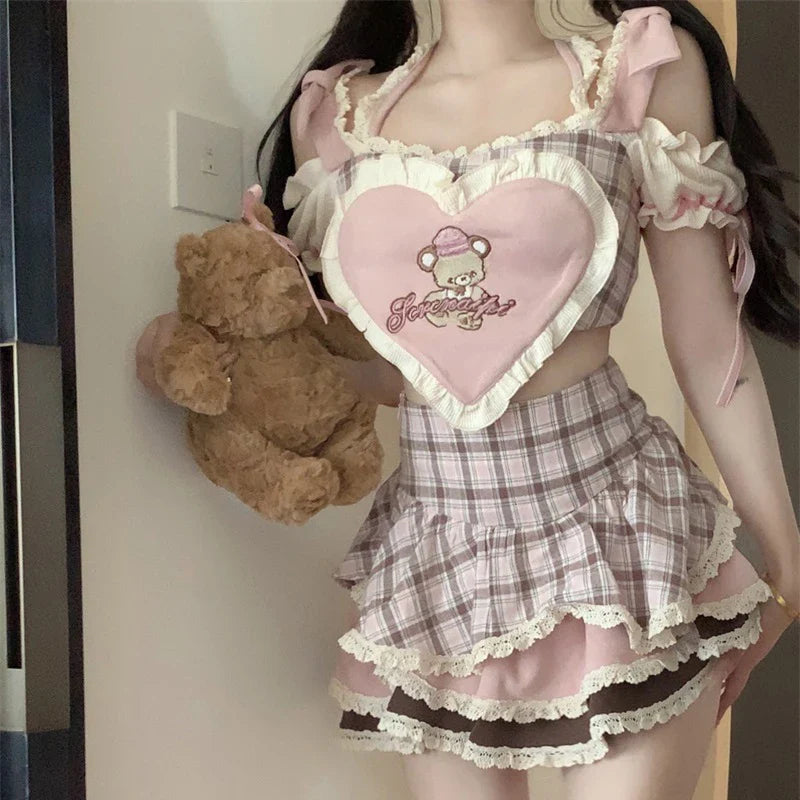 Kawaii lolita skirt set in pink plaid with lace trim and heart-shaped chest design holding teddy bear