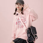 Pink Harajuku cute print sweatshirt with cartoon designs worn with black plaid skirt and black cap