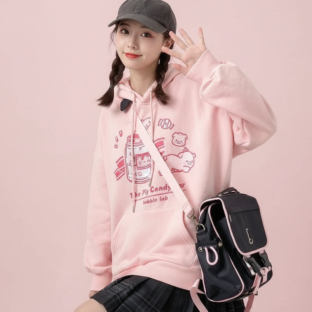 Pink Harajuku cute print sweatshirt with cartoon designs worn with black plaid skirt and black cap
