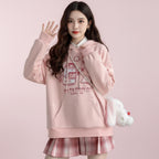 Pink Harajuku cute print sweatshirt with cartoon graphics and front pocket worn with plaid skirt