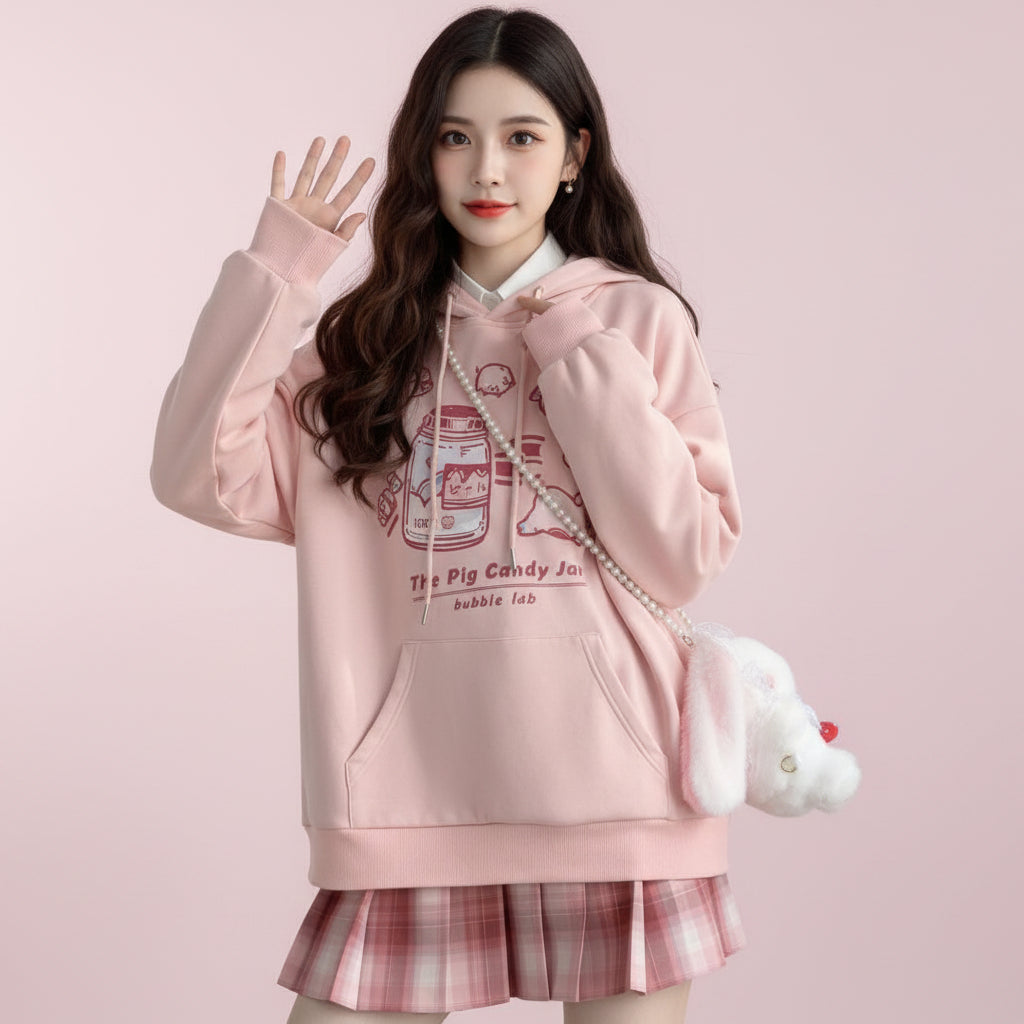 Pink Harajuku cute print sweatshirt with cartoon graphics and front pocket worn with plaid skirt