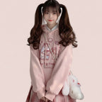 Harajuku cute print sweatshirt in pink with cartoon candy jar design worn with plaid skirt