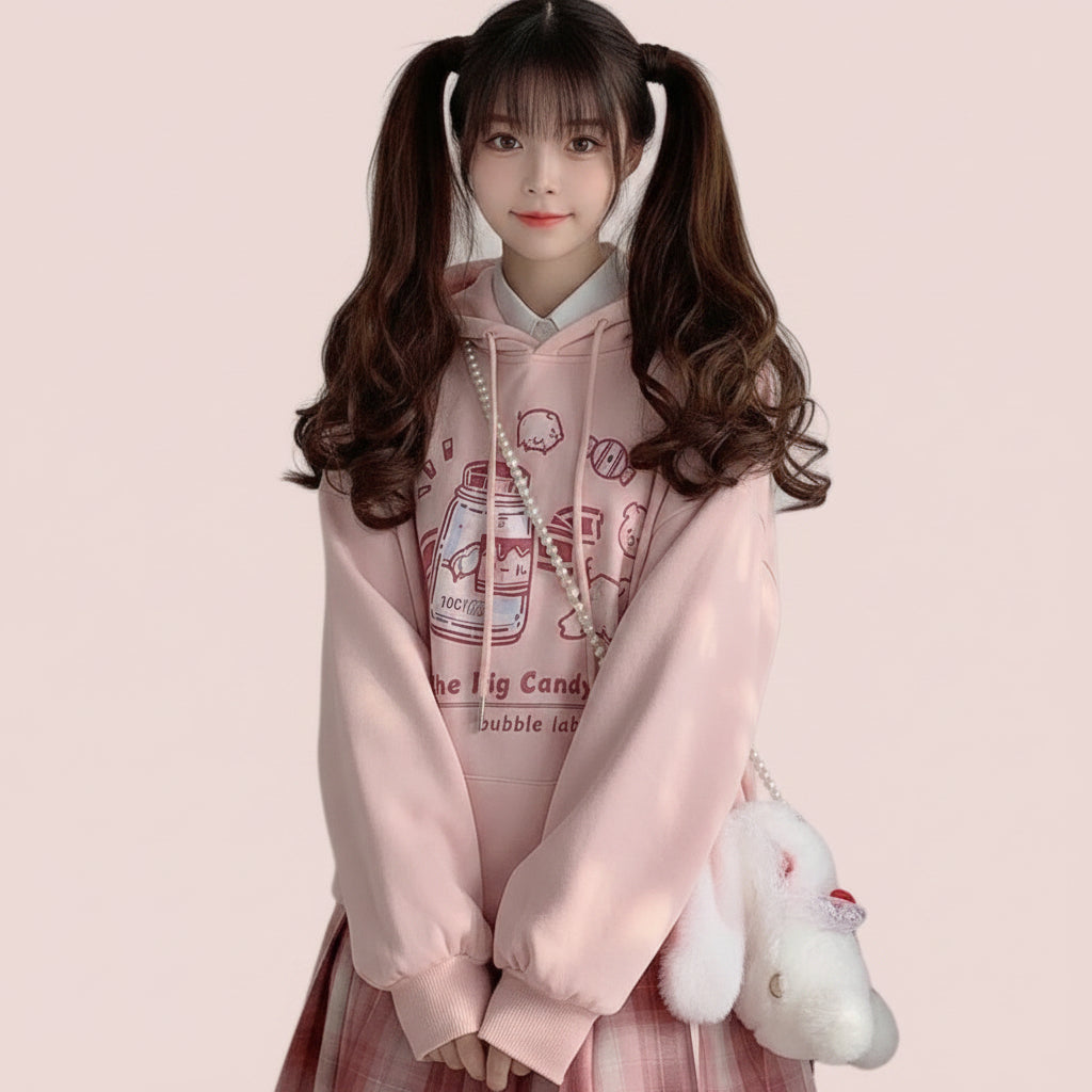 Harajuku cute print sweatshirt in pink with cartoon candy jar design worn with plaid skirt
