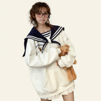 Woman wearing japanese harajuku bear oversized hoodie holding a teddy bear in a cozy room
