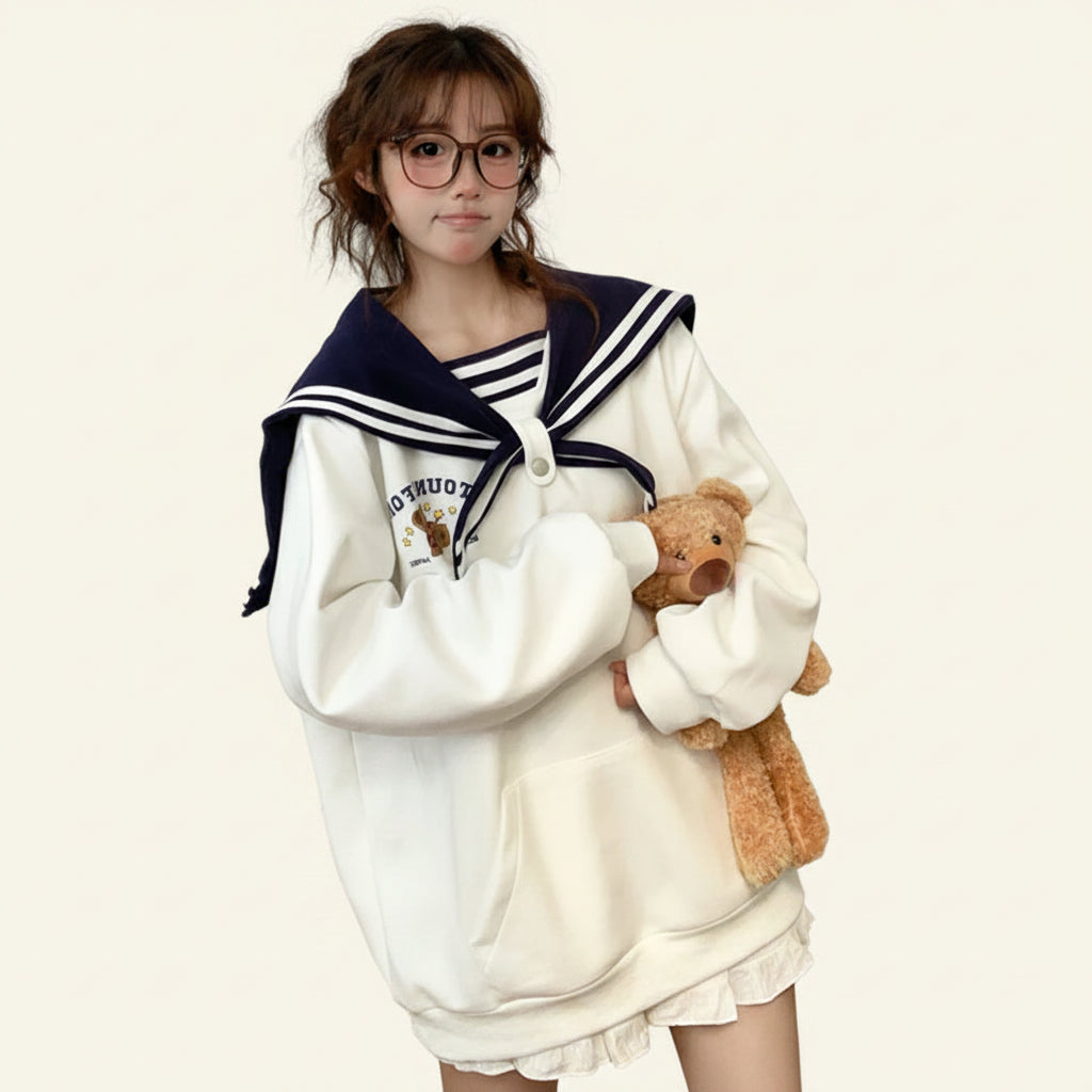 Woman wearing japanese harajuku bear oversized hoodie holding a teddy bear in a cozy room