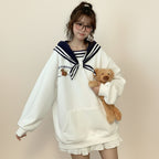 Young woman wearing japanese harajuku bear oversized hoodie white with navy sailor collar holding teddy bear