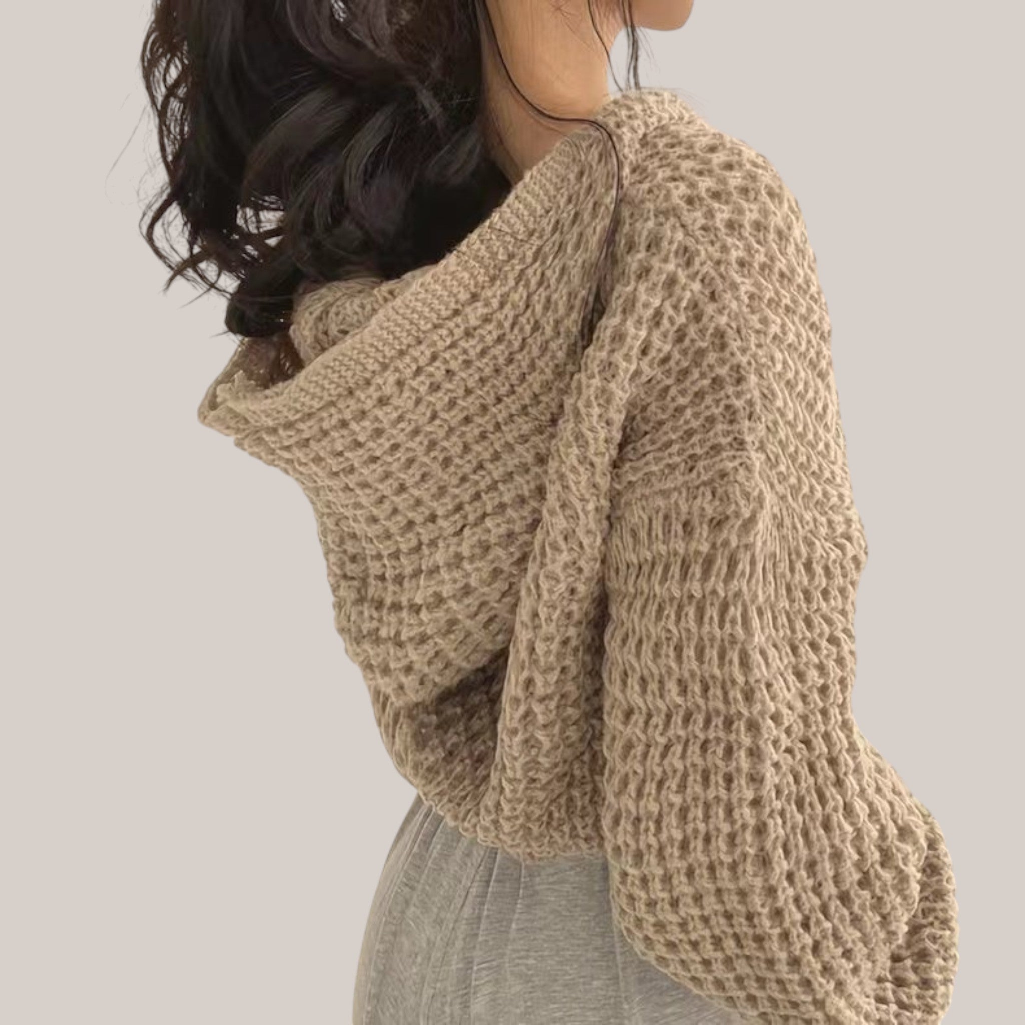 Vusy Kawaii Shop Official beige knit oversized hoodie with waffle texture and drawstring hood, worn by a woman with dark hair.