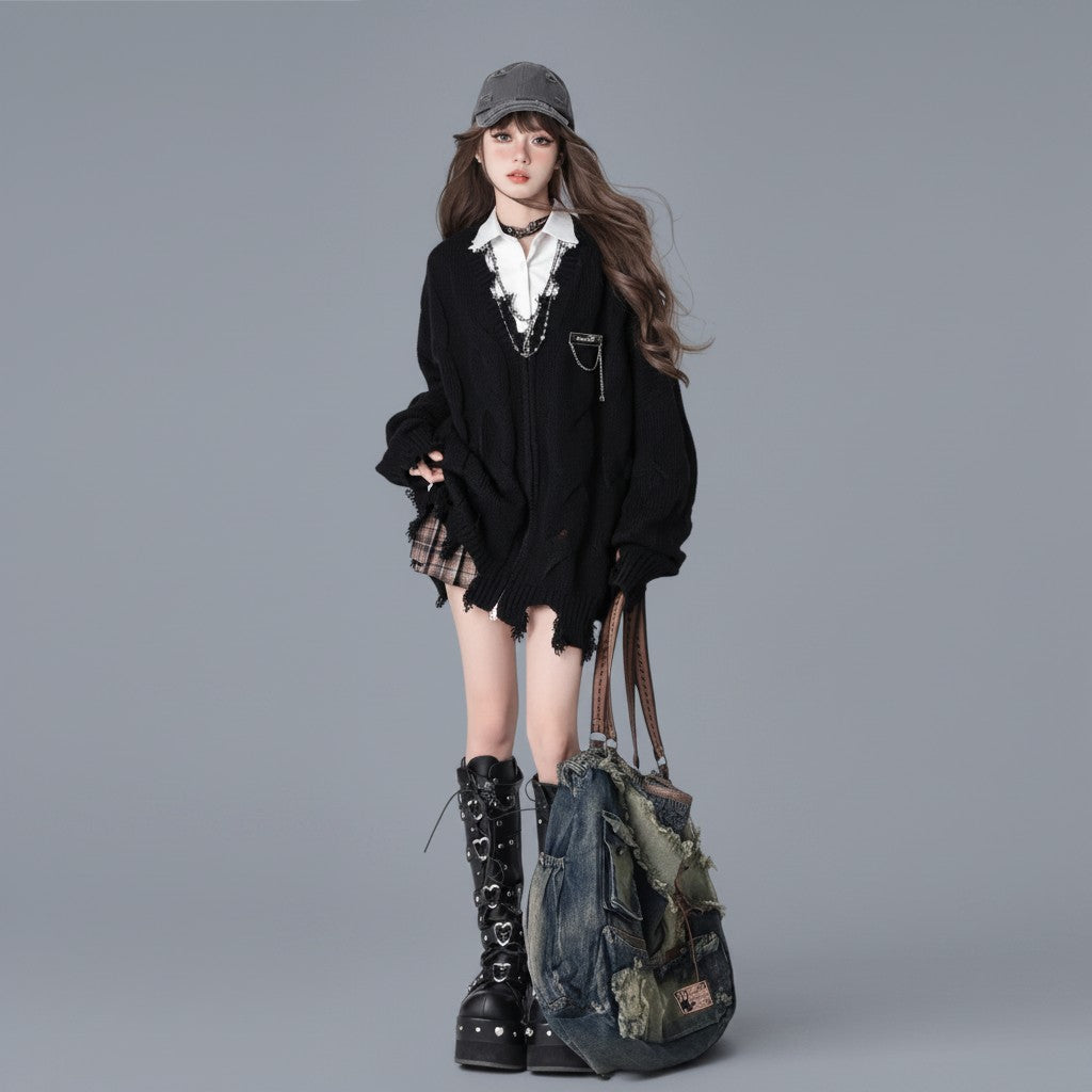 Vusy Kawaii Shop Official black distressed V-neck acrylic knit sweater with chain detail, layered over a white shirt and plaid skirt.