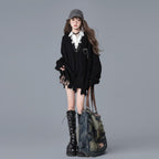 Vusy Kawaii Shop Official black distressed V-neck acrylic knit sweater with chain detail, layered over a white shirt and plaid skirt.