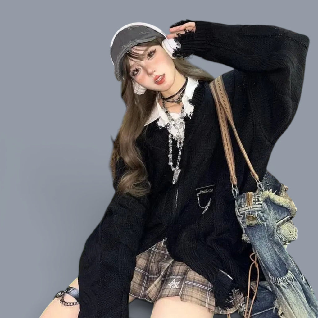 Vusy Kawaii Shop Official black loose V-neck acrylic knit sweater with distressed details, layered over a white shirt and plaid skirt.
