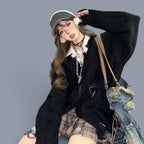 Vusy Kawaii Shop Official black loose V-neck acrylic knit sweater with distressed details, layered over a white shirt and plaid skirt.