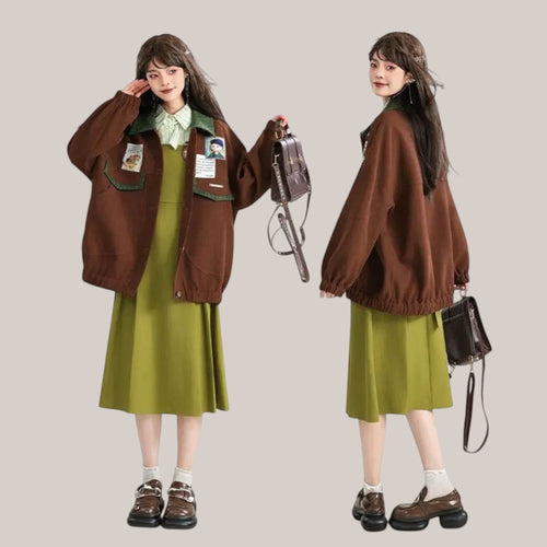 Vusy Kawaii Shop Official brown polyester-cotton blend bomber jacket with green collar and patches, worn by a model with a green dress.