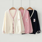 Vusy Kawaii Shop Official cream, pink, and navy knitted cardigans with bunny and carrot embroidery. Features V-neck, button closure, and pockets.