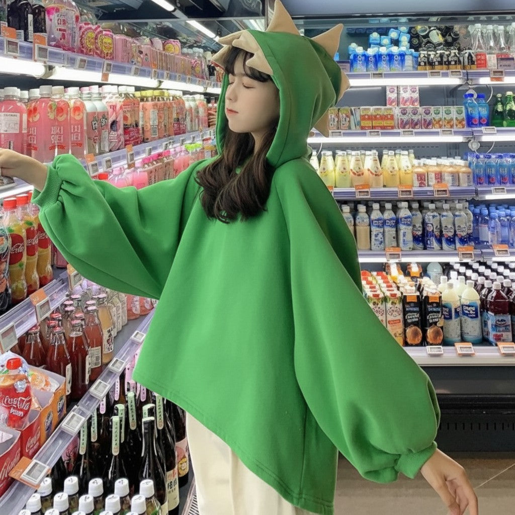 Vusy Kawaii Shop Official green oversized hoodie with dinosaur spikes on the hood, made from a cotton-polyester blend.