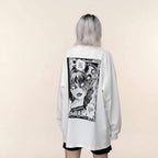 White women's streetwear anime pullover with black manga graphic on back worn by model