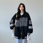 Women's retro denim baseball jacket with black sleeves and frayed chest pockets styled casually indoors