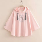 Pink women's spring autumn cute sweatshirt with wide sleeves and tassel details hanging on a hook