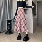 Woman wearing Women's Spring Fall Preppy Bandage Knit Vest & Plaid Skirt Set with black cropped top and pink plaid skirt