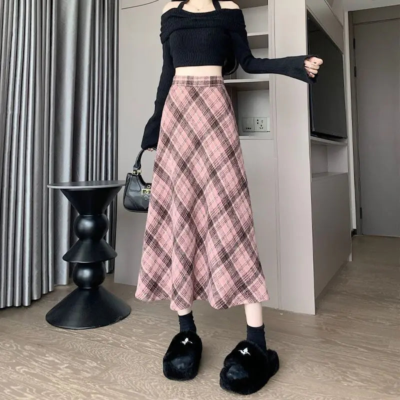 Woman wearing Women's Spring Fall Preppy Bandage Knit Vest & Plaid Skirt Set with black cropped top and pink plaid skirt