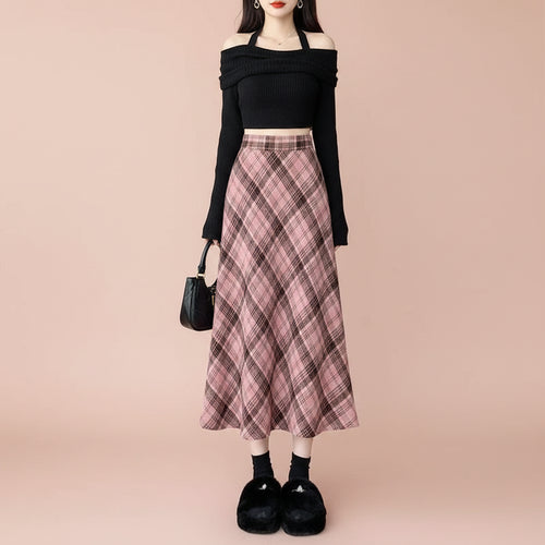 Woman wearing Women's Spring Fall Preppy Bandage Knit Vest & Plaid Skirt Set with black cropped top and pink plaid skirt