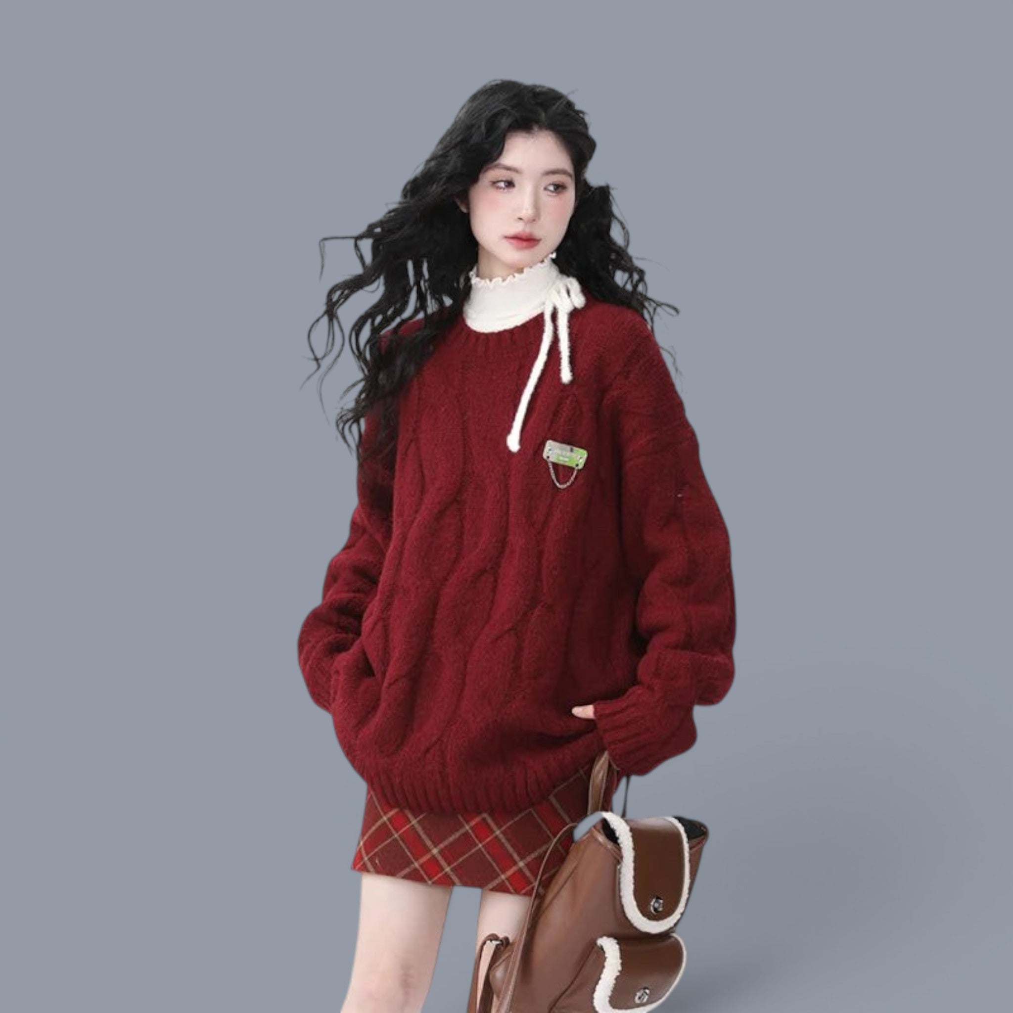 Cozy chunky knit cute style sweater women in deep red worn with plaid skirt and brown backpack