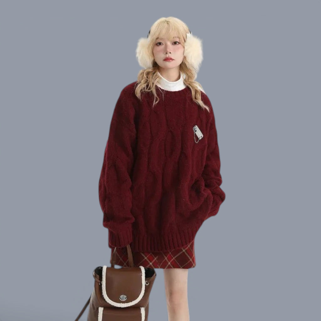 Cozy chunky knit cute style sweater women in burgundy worn with plaid skirt and fluffy earmuffs