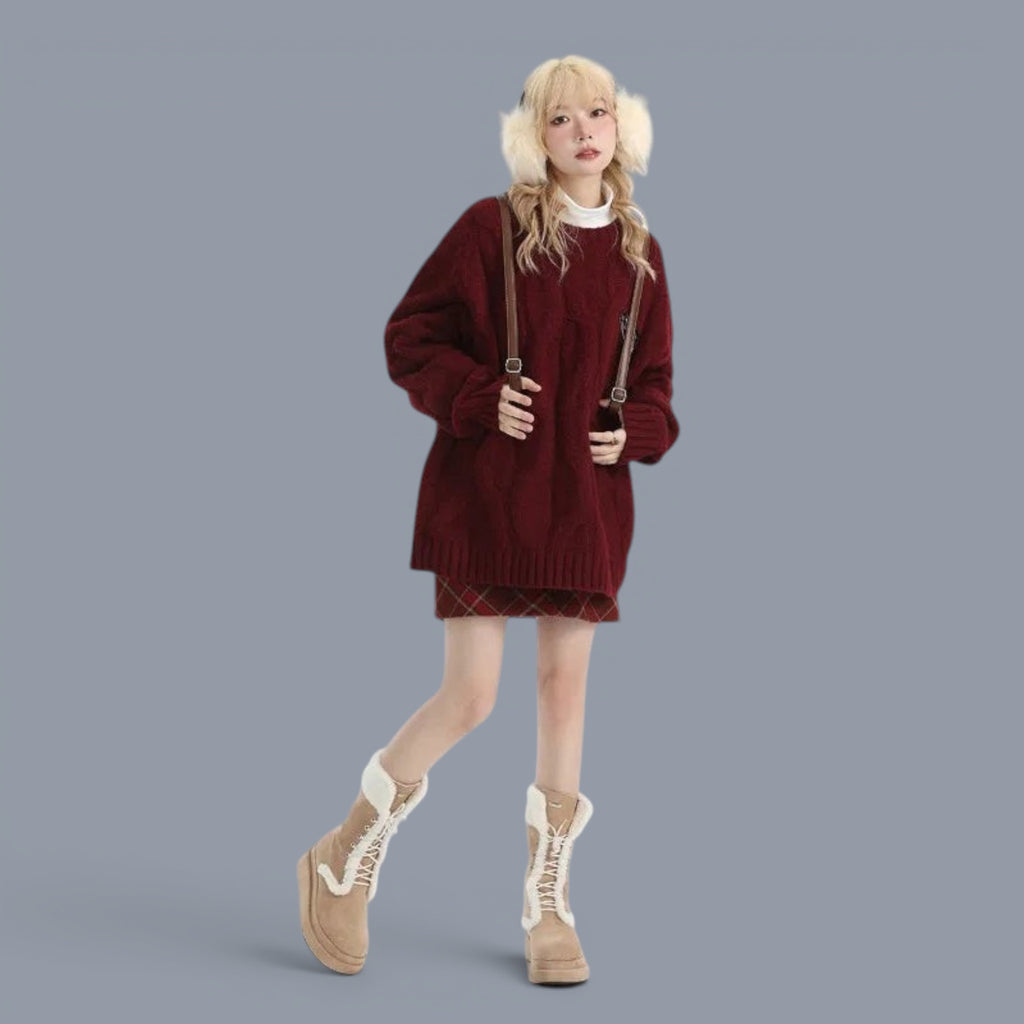 Woman wearing cozy chunky knit cute style sweater women in burgundy with beige boots and fluffy ear muffs