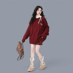 Women modeling cozy chunky knit cute style sweater women in deep red with brown plaid skirt and beige boots