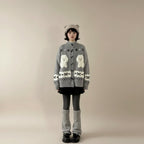Woman wearing cute dog cartoon sweater for women in gray with white dog designs and black skirt