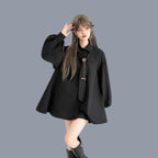 Woman wearing a gothic loose long sleeve top in black with balloon sleeves and a tie detail