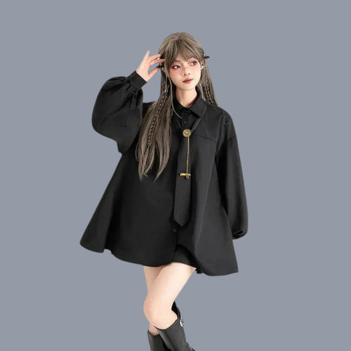 Woman wearing a gothic loose long sleeve top in black with balloon sleeves and a tie detail