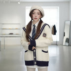 Young woman wearing oversized knit cute sweater coat for women holding a plate of bread indoors