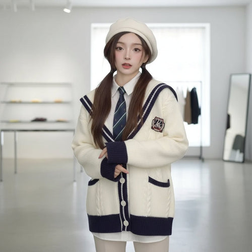 Young woman wearing oversized knit cute sweater coat for women holding a plate of bread indoors